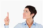 Close up of a businesswoman pointing at copy space against a white background