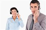 Office workers using headsets against a white background