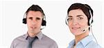 Close up of managers using headsets against a white background