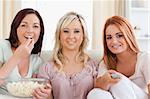 Smiling Friends lounging on a sofa watching a movie in a living room