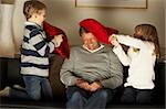 Father And Two Children In Pillow Fight