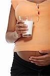 Pregnant belly with glass of milk , isolated on white