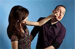 Young woman punching men in a face