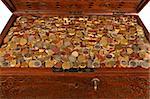 Euro coins piled in an old treasure chest