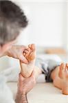 Woman getting a reflexology massage in a room