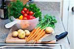 Freshly washed vegetables and herbs on a cutting board