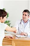 Male Doctor greeting a patient in a room