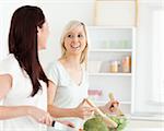 Cheering Women preparing dinner in a kitchen