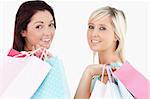 Cheering women with shopping bags in a studio