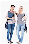 Portrait of smiling College students holding books in a studio