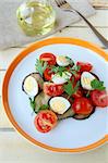 salad with eggplant, tomato and quail eggs