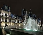 The lit fountains in front of the Hotel de Ville in Paris at night, nicely illuminated to show the "grandeur" of the city