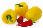 Yellow bell pepperand glass ornament chilli pepper, isolated on white backgrund