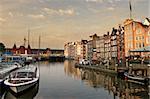 View on city canal (Amstel river) with cruise ship in Amsterdam, Netherlands.