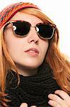 cool redhead woman wearing sunglasses in winter dress on white background