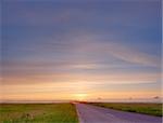 Bright sunrise over countryside empty road