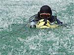 A diver diving in the icy lake