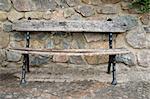 park bench against the stone wall