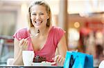 Woman Eating A Piece Of Cake At The Mall