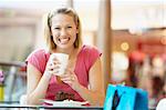 Woman Eating A Piece Of Cake At The Mall