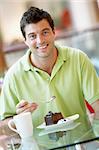 Man Eating A Piece Of Cake At The Mall