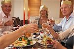 Friends Wearing Party Hats At A Dinner Party