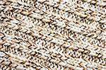 Knitted brown and white wool fabric, background.