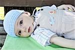 Portrait of three months old baby boy wearing  blue summer  hat