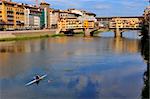 Vecchio Bridge , Florence , Italy, with rower passing by