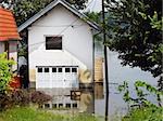 house surrounded by water in river during spring flood in Serbia