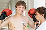 Close-up portrait of a young doctor checking a smiling boxer