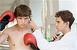 Close-up photo of a young doctor checking an angry boxer