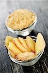 Sliced and ground fresh ginger root spice in glass bowls