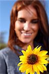 Beautiful Red Haired Woman Outdoors in a Sunflower Field