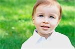 Close-up portrait of a smiling baby at the park