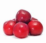 a pile of plums on a white background