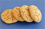 four fresh appetizing oatmeal cookies over blue background