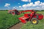 A mower drawn beside a tractor cuts a field of alfalfa in southern Wisconsin.