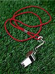 A sports umpires whistle isoltaed on grass