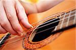 Closeup of a guitarist playing acoustic guitar