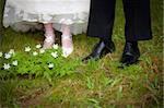 Just married couple walking on gras inside a forest