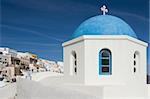One of the famous blue dome chapels in the village of Oia, Santorini, Greece