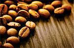 Coffee beans background macro shot on wooden background with copyspace