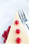 Cheese cake with cranberries on a white plate