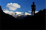 Silhouette of a climber with snow coverd peak in the background