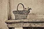 wicker basket on a bench, black and white filter