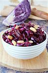 Red cabbage salad with nuts in a white cup