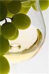 wineglass with white wine and grape