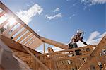 Low angle view of a carpenter hammering wall headers