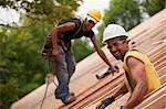 Carpenters working on the roof of a house under construction